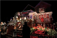 A man stands outside a decorated house at the Dyker Heights Christmas Lights in the Dyker Heights neighborhood of Brooklyn, New York City, U.S., December 23, 2016. REUTERS/Andrew Kelly - RTX2WCP0