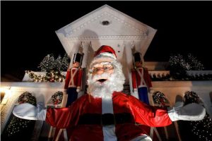 A large Santa Claus sits at the entrance of a decorated house at the Dyker Heights Christmas Lights in the Dyker Heights neighborhood of Brooklyn, New York City, U.S., December 23, 2016. REUTERS/Andrew Kelly - RTX2WCOR