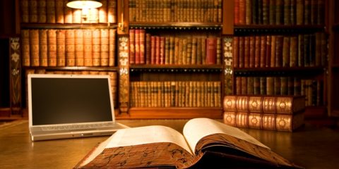 Laptop in classic library with books in background series