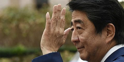 (FILES) In this file photo taken on October 19, 2018 Japan's Prime Minister Shinzo Abe waves as he leaves after attending an EU - Korea Summit meeting at the European Council in Brussels. - Abe has been confirmed dead after he was shot at a campaign event in the city of Nara on July 8, 2022, public broadcaster NHK and Jiji news agency reported. (Photo by JOHN THYS / AFP)